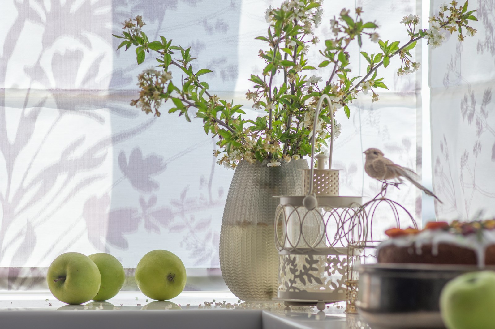 green apple fruit beside clear glass vase